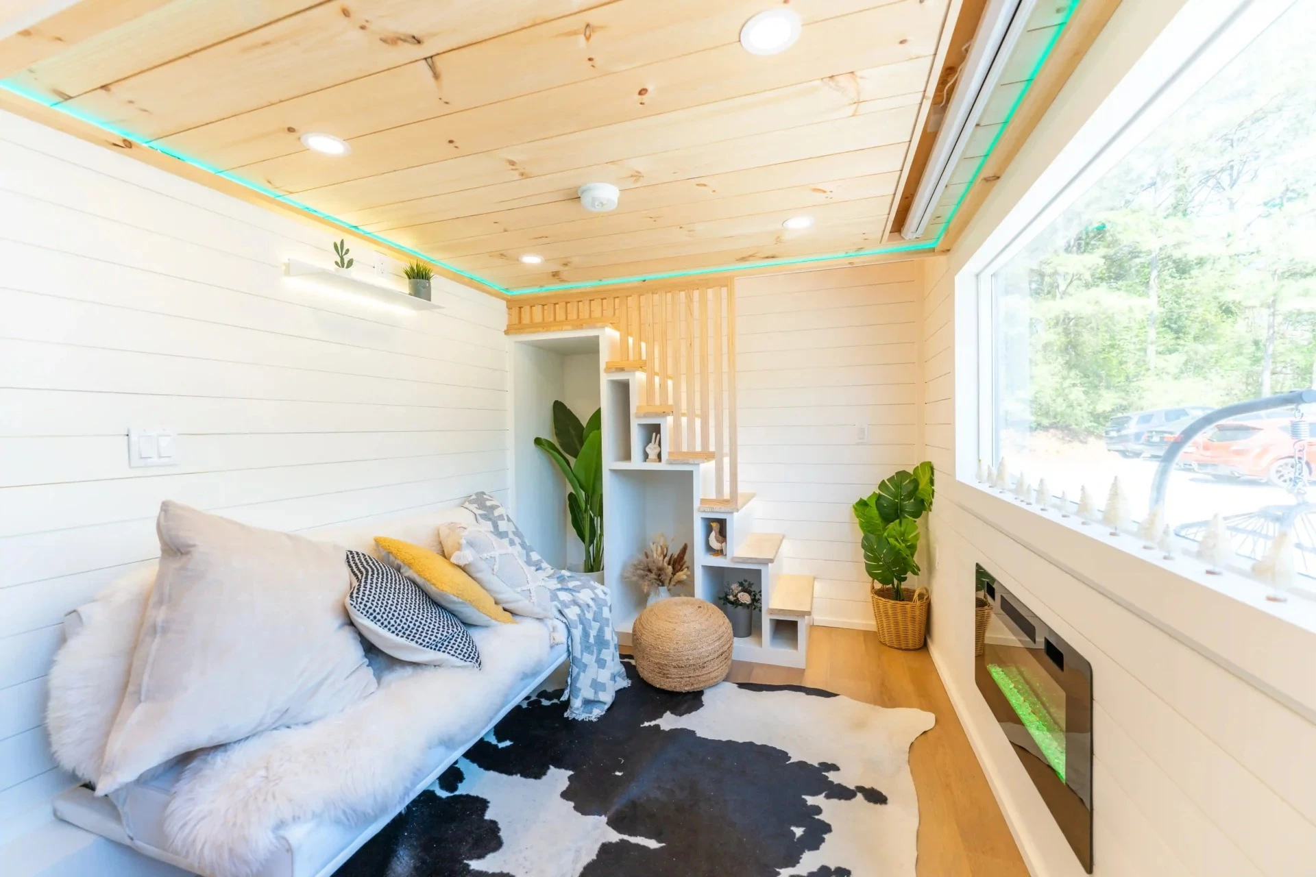 The Premium Vista's living room includes a sofa and an electric fireplace, plus it has a pull-down projector screen (but you'll need to provide your own projector)