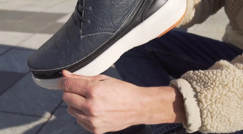 The Chukka-style skin, getting zipped onto one of the soles