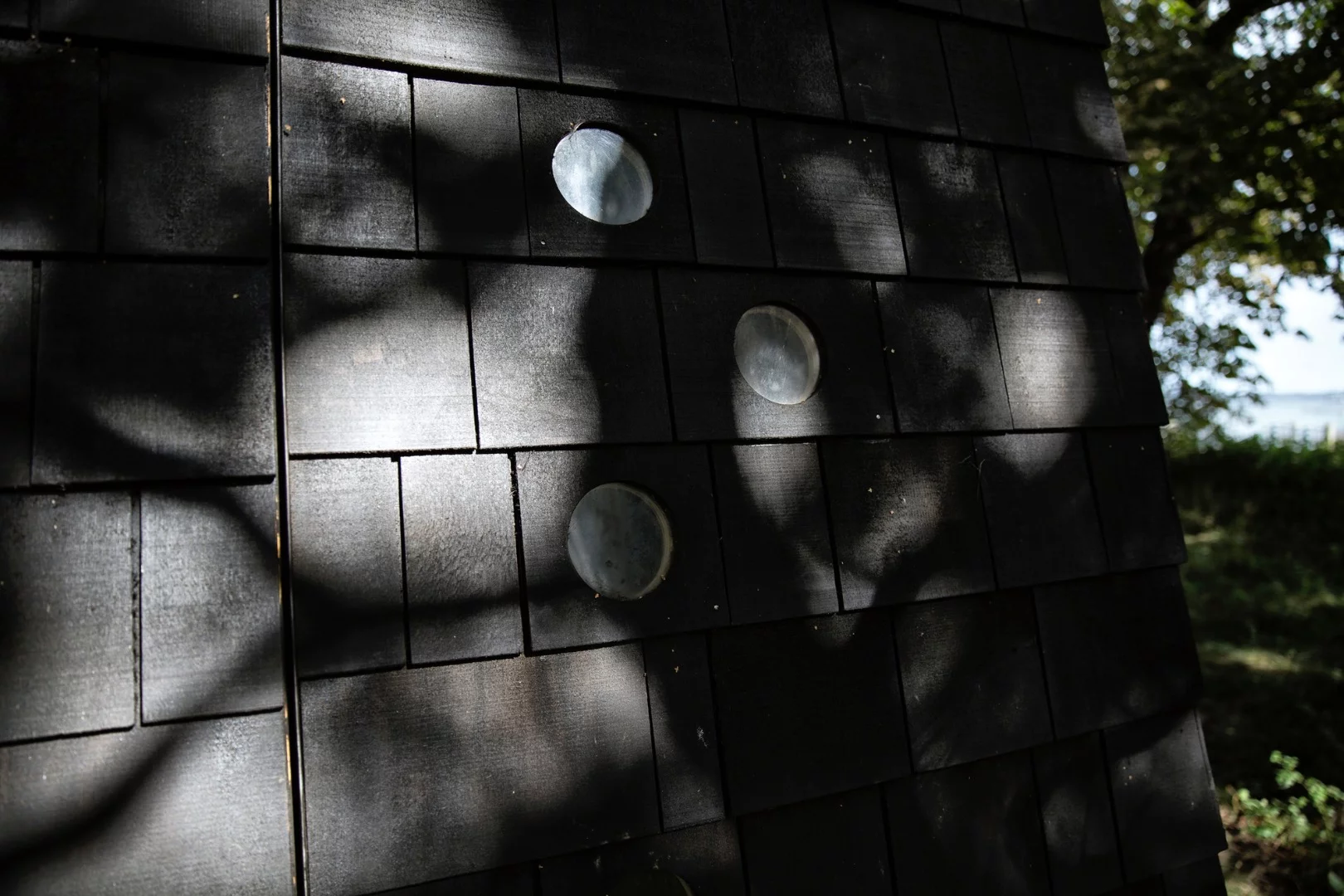 Each of the asymmetrical shelters sports small porthole-like lookouts