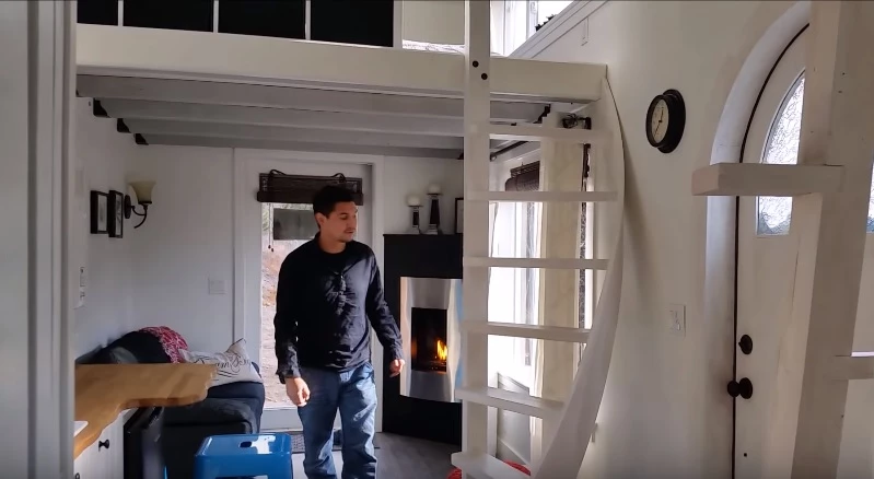 The interior of of the home features a propane fireplace and beautiful wooden floorboards