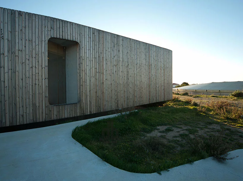 Vertical wooden panels wrap around the structure