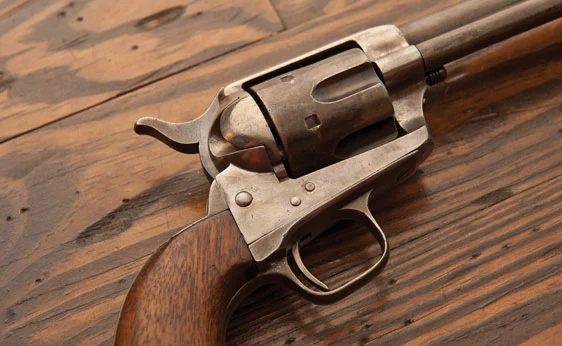 Colt Single Action Army Revolver 1874. This example was in the fifth lot received from Colt to the U.S. Government and has been rebuilt by modifying the barrel length to 5.5 in., possibly for either the Spanish American War or the Philippine Insurrection. It features a six round cylinder with a three screw frame and walnut grips. Expected to bring US$6,500-9,500.
