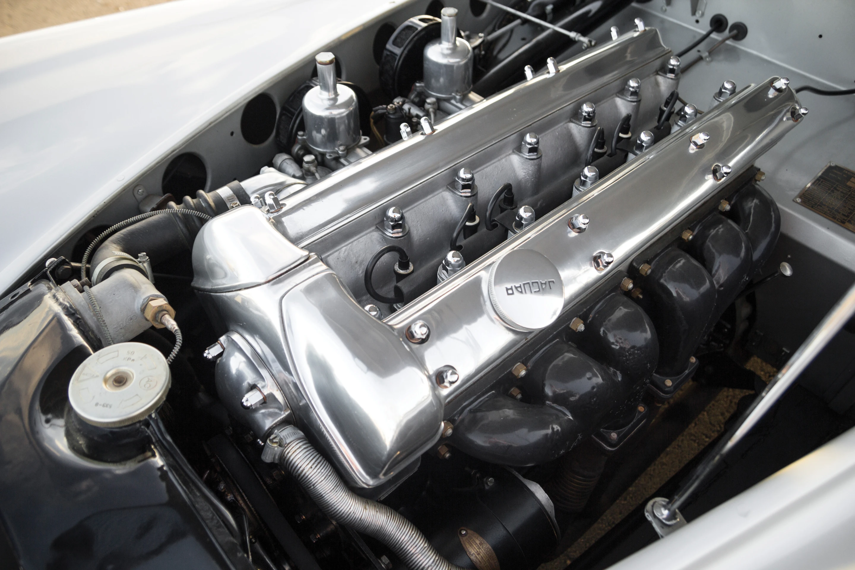 The Jaguar XK120 runs on a 160 bhp, 3,442 cc DOHC inline six-cylinder engine with twin SU H6 carburetors