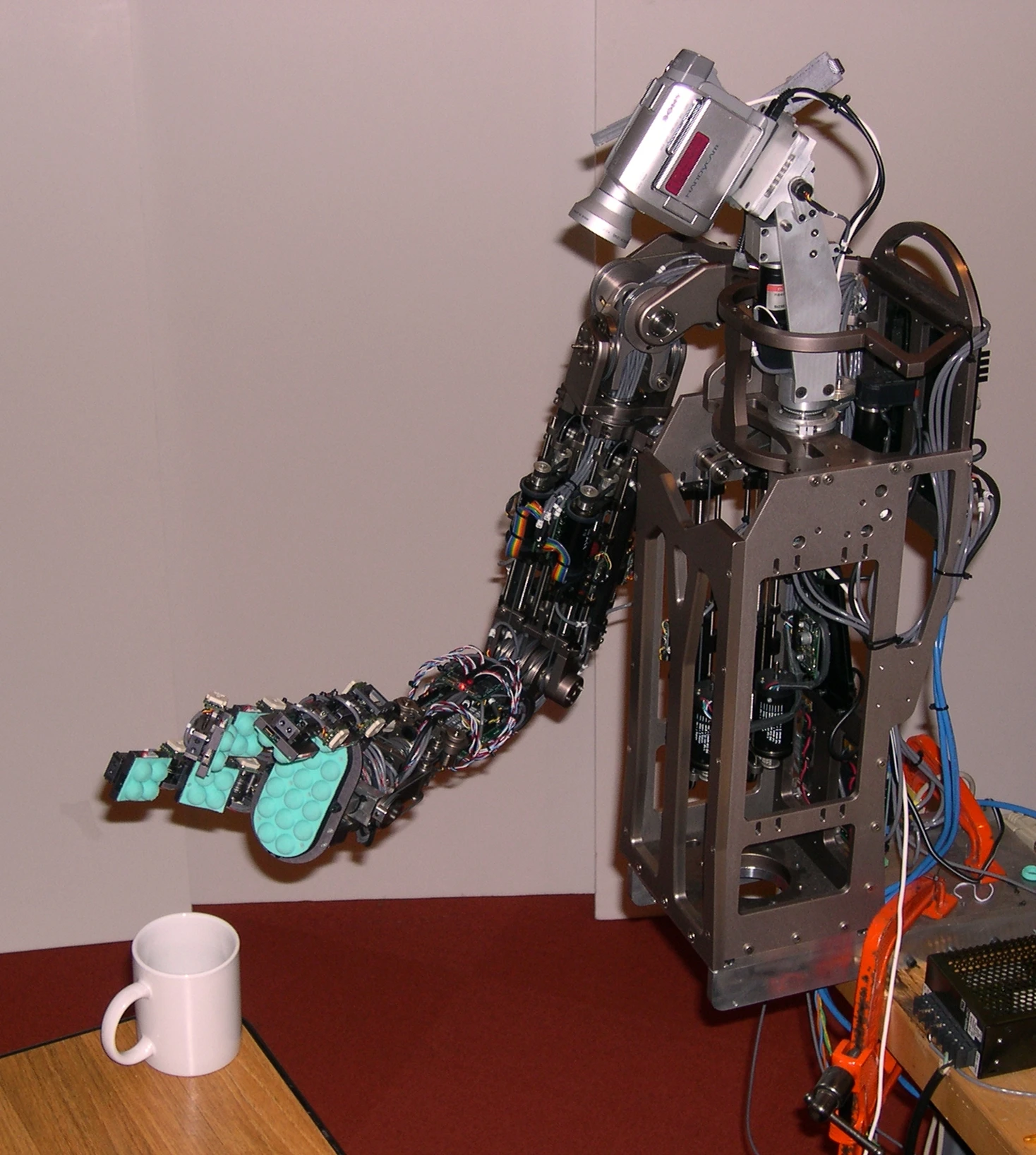 Torres-Jara's Obrero robot, seen here about to lift a ceramic mug