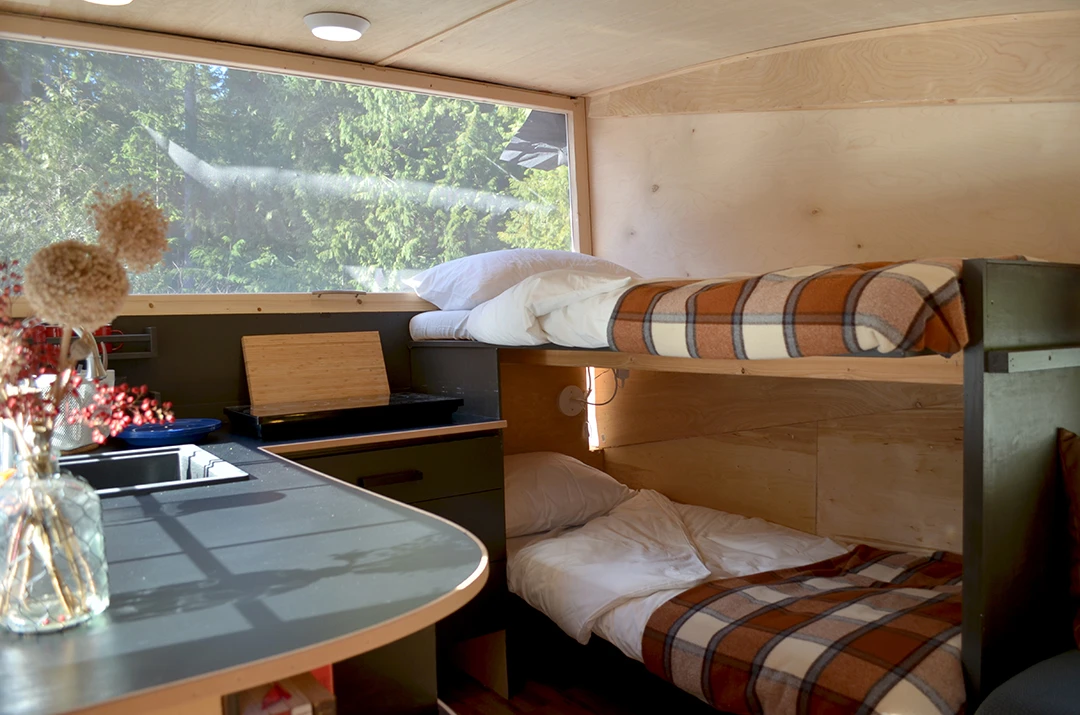 It includes a couch that pulls out into a double bed and two smaller bunk beds