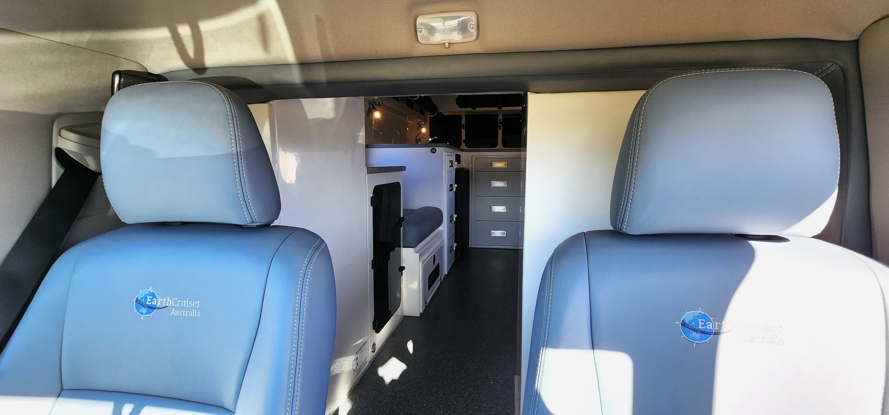 The two-seat driver's cab has a pass-through to the cabin, where the two additional drive seats with belts are loacated