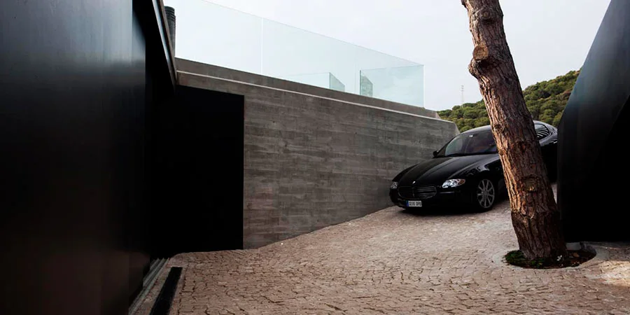 X House features a garage on the upper floor with room for two cars