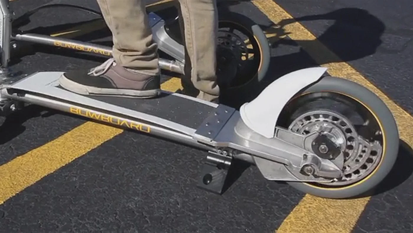 Pushing down on the bowed board engages the patented spiral gearing mechanism at the single big wheel to the rear
