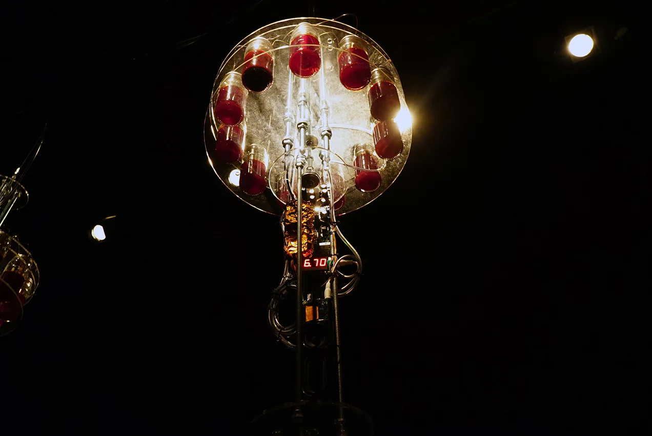 The centrally-positioned synth stack includes voltage converters, buffer capacitors, an Axoloti sound module, a small booster with speakers and a display that shows the voltage after the conversion