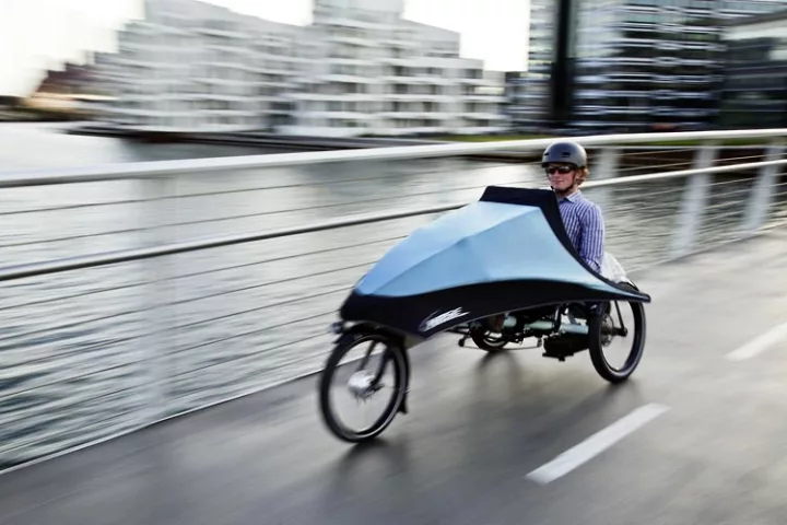 Hase Bikes' KLIMAX tricycle features a detachable folding fairing, allowing users to add weather protection as needed