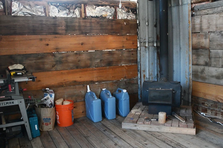 Once the cabin was erected and their living space increased, the couple further prepared for winter by installing a wood-burning stove