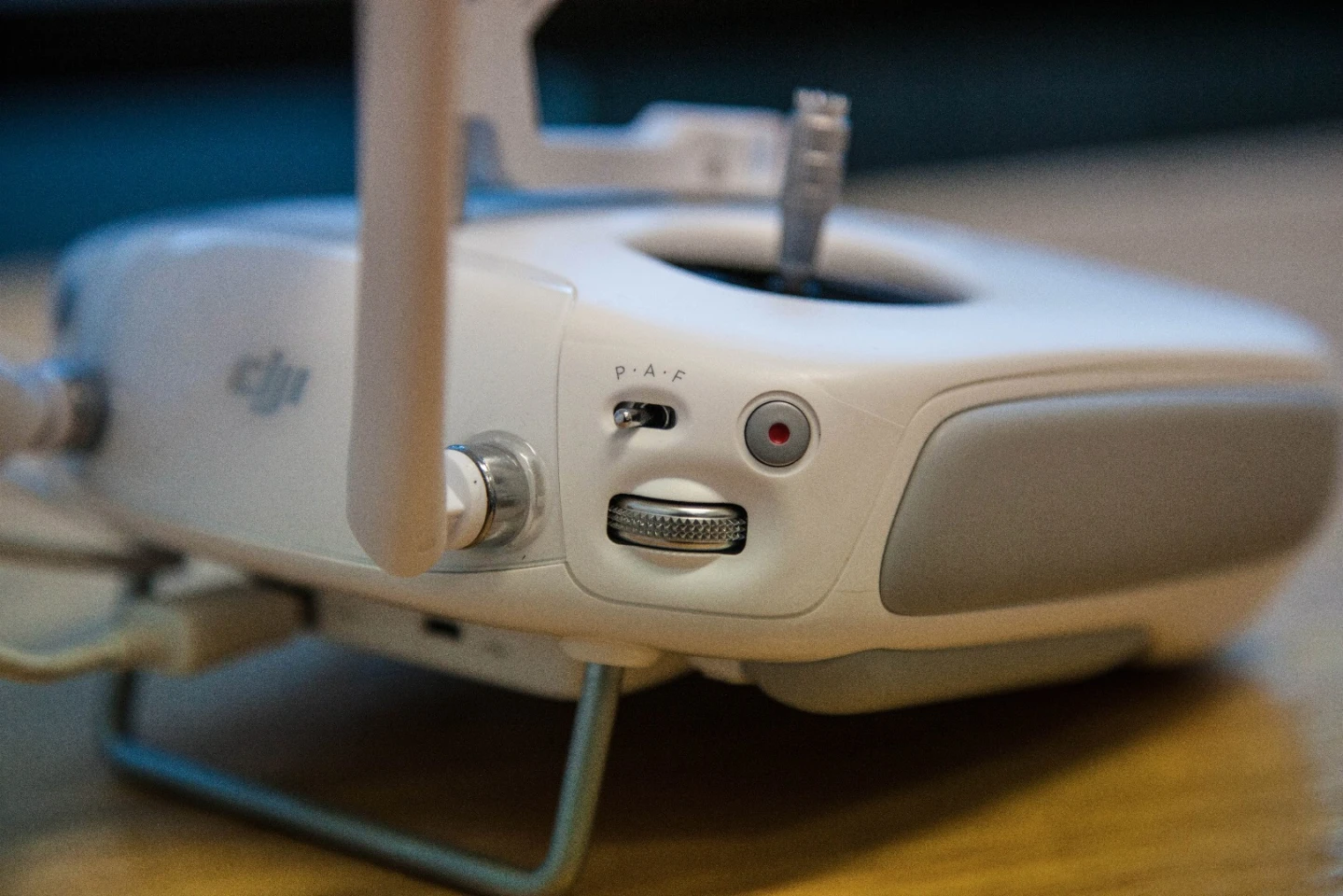 Phantom 3 controller - left finger controls include start/stop video, the mode switch and the camera pitch control wheel