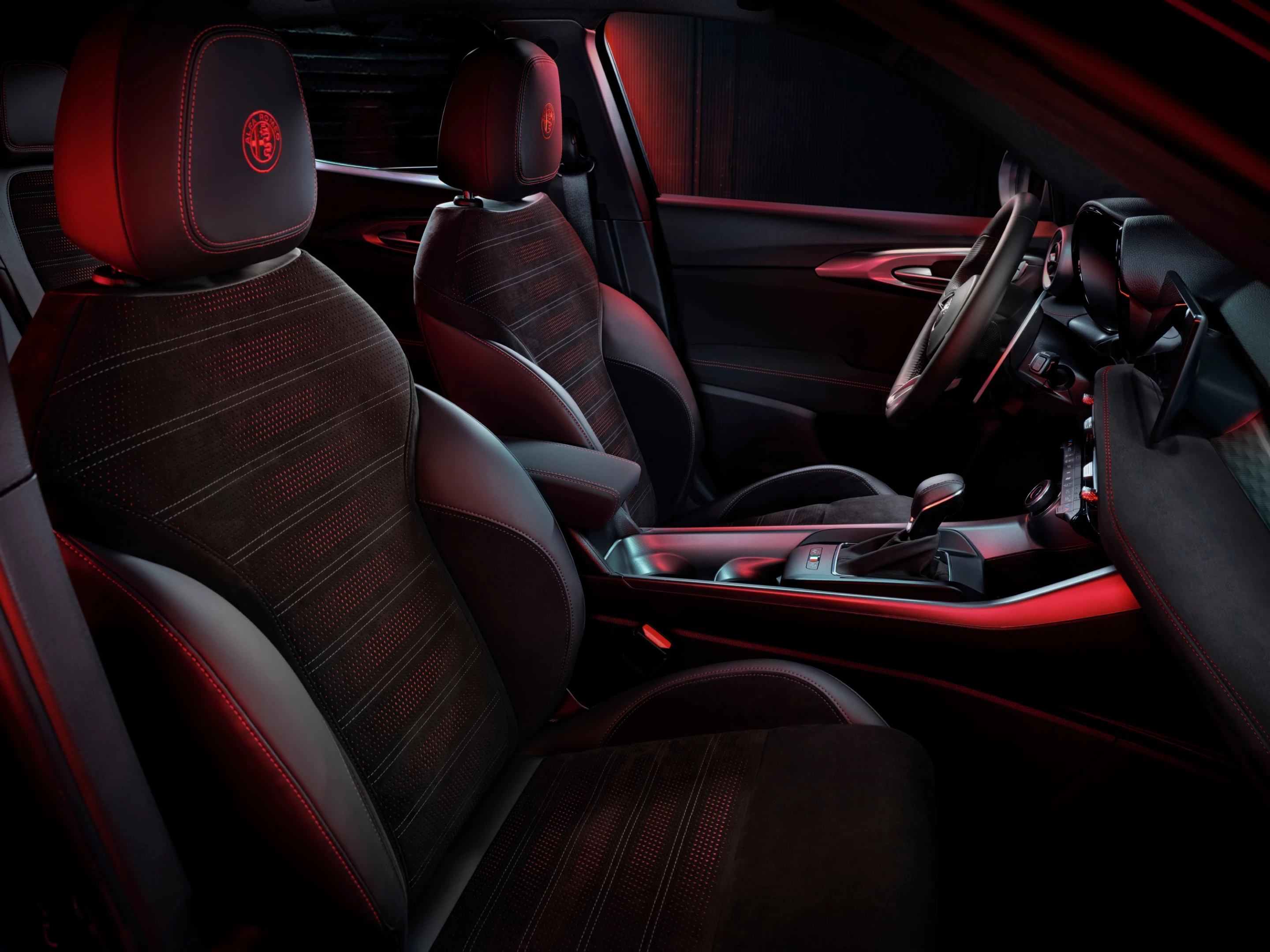 Alfa Romeo promises a driver-focused cockpit with a mix of leather, Alcantara and aluminum