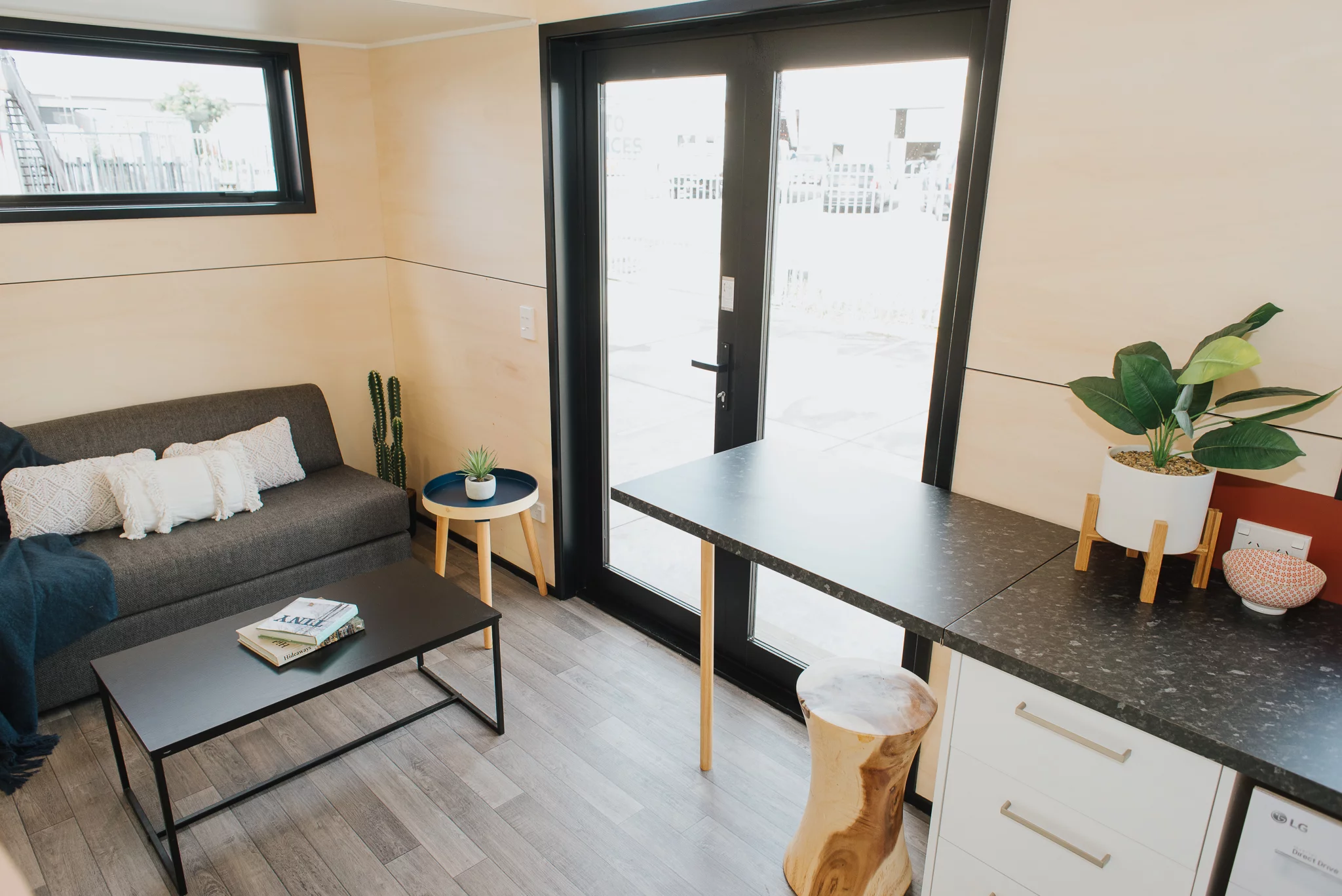 Visitors enter the Daisy Vera Tiny House into the living room