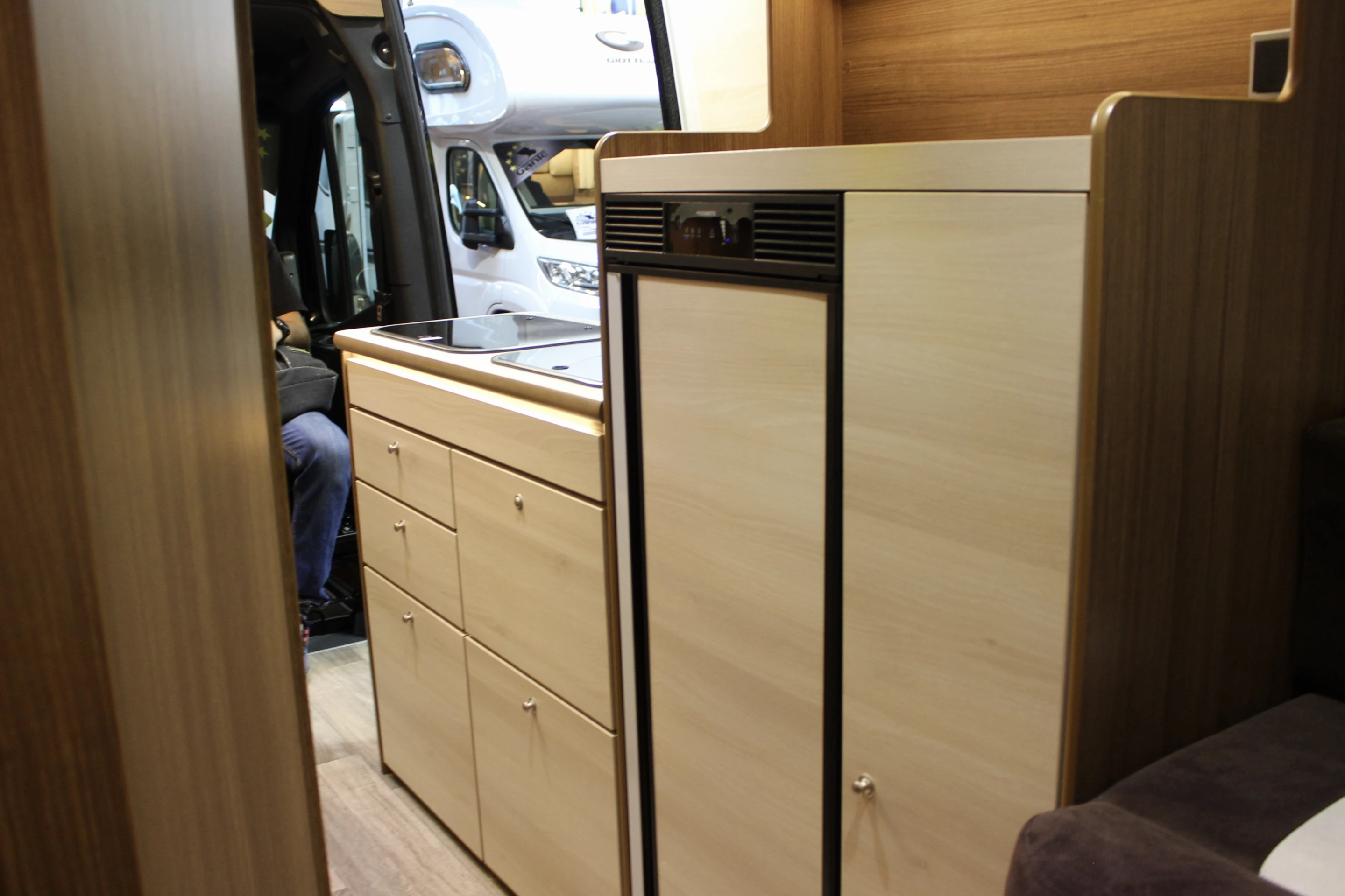 The kitchen includes a large console next to the main stove/sink block