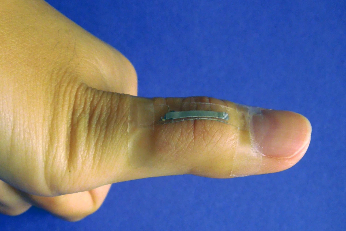 A silver nanowire-based sensor mounted onto a thumb joint to monitor the skin strain associated with thumb flexing (Photo: Shanshan Yao)