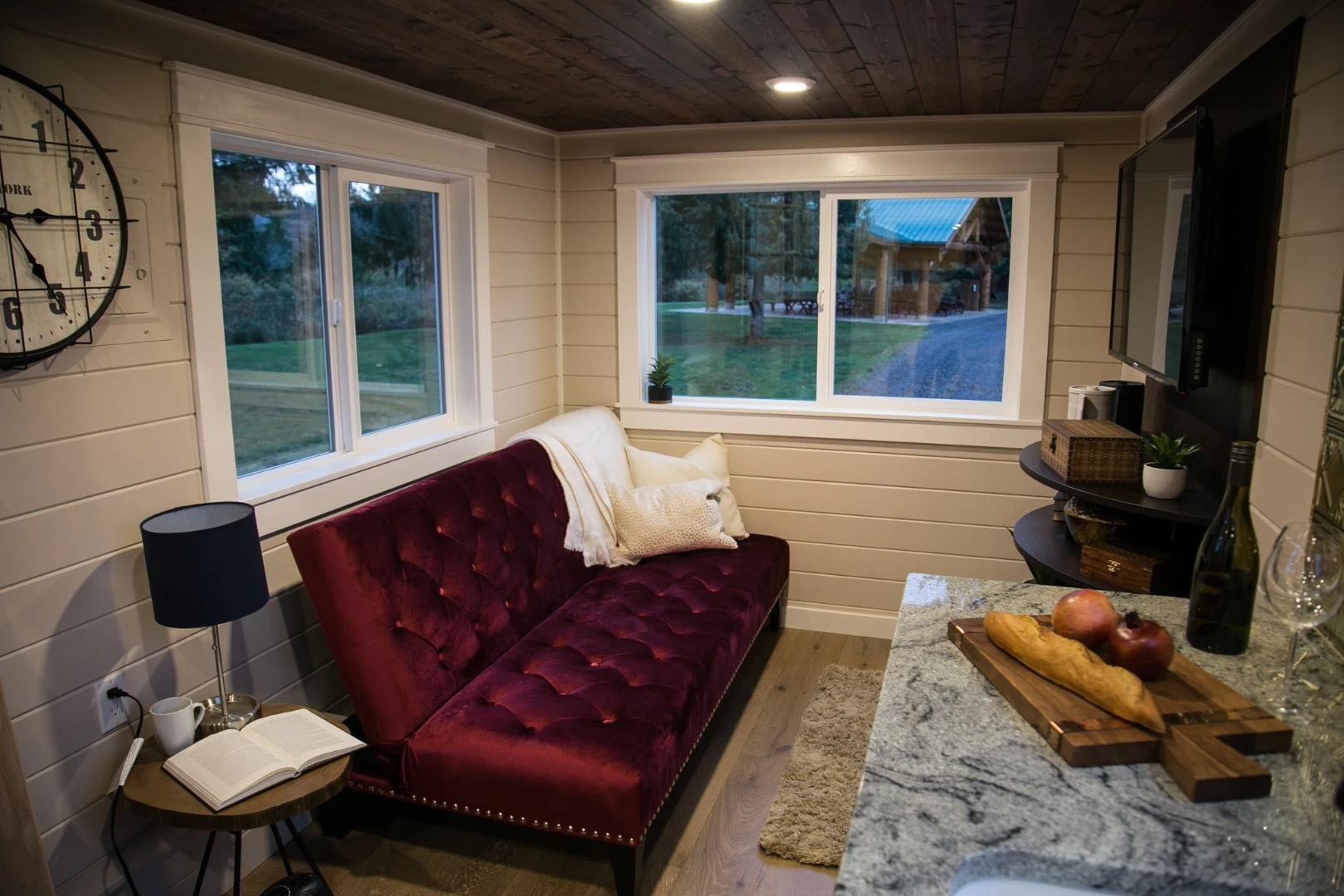 The Theater Home's living room includes a custom sofa bed that sleeps two and an entertainment center with large TV