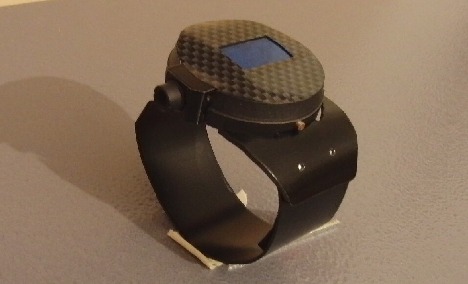 The watch features a machined metal body, a clear-coated carbon fiber face, a salvaged LED watch module and most notably, a 1,500-milliwatt laser module