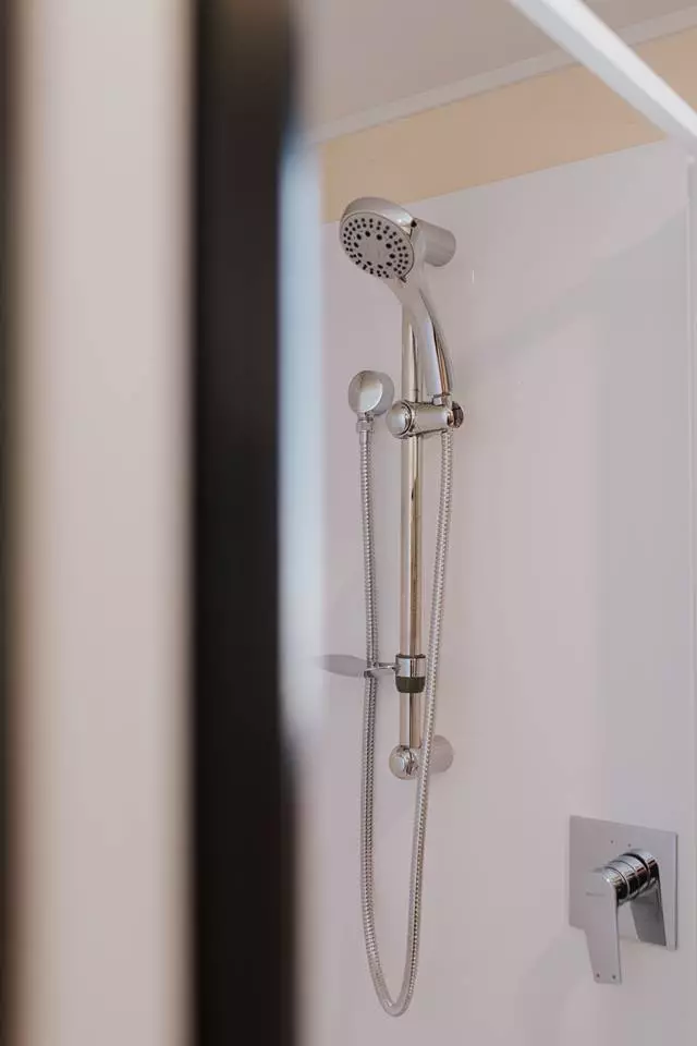 La Sombra Tiny House's bathroom includes a shower, sink, and composting toilet