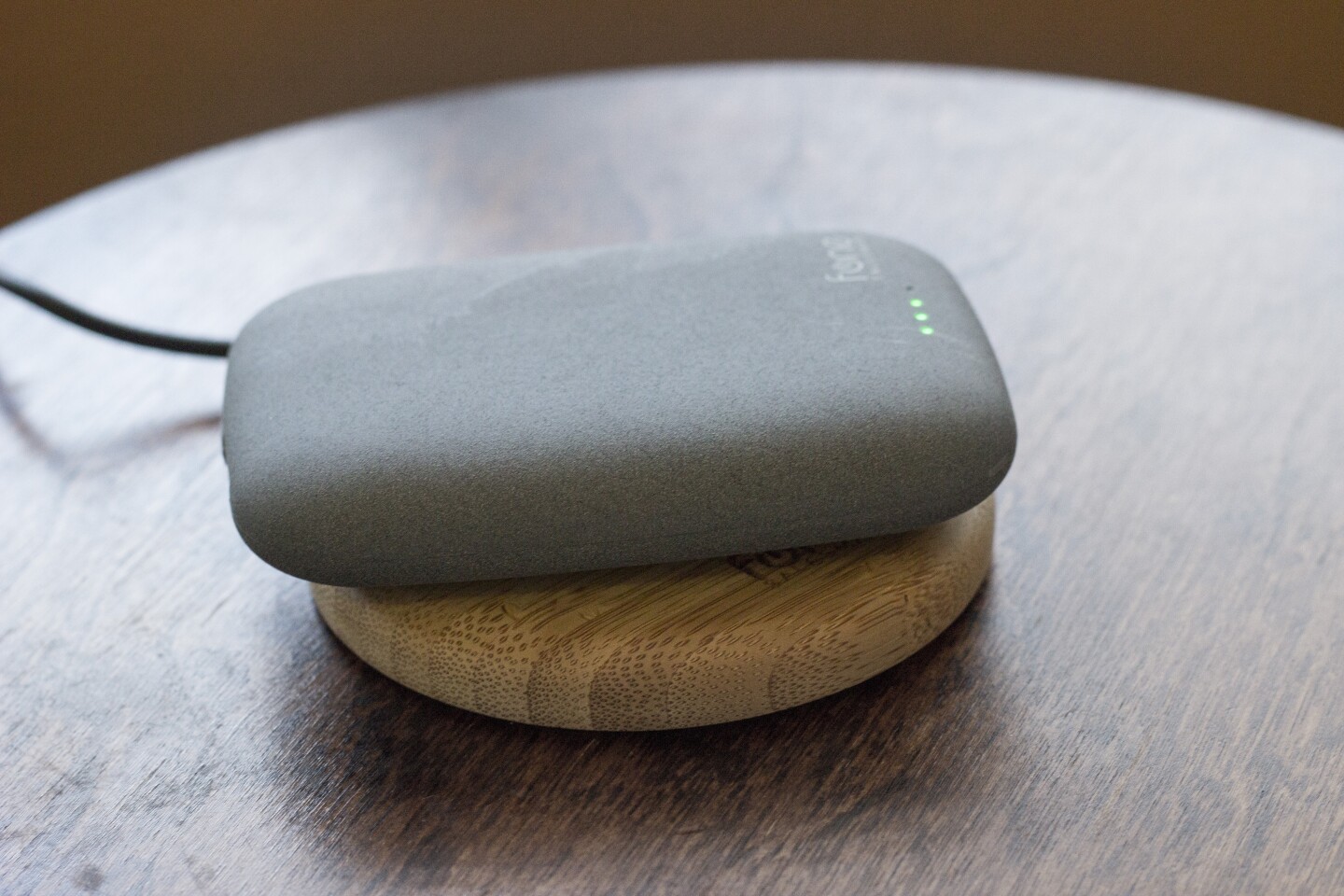 The Qistone+ Wireless Power Bank can be wirelessly-charged itself, as it's doing here on top of the WoodPuck (Photo: Will Shanklin/Gizmag.com)