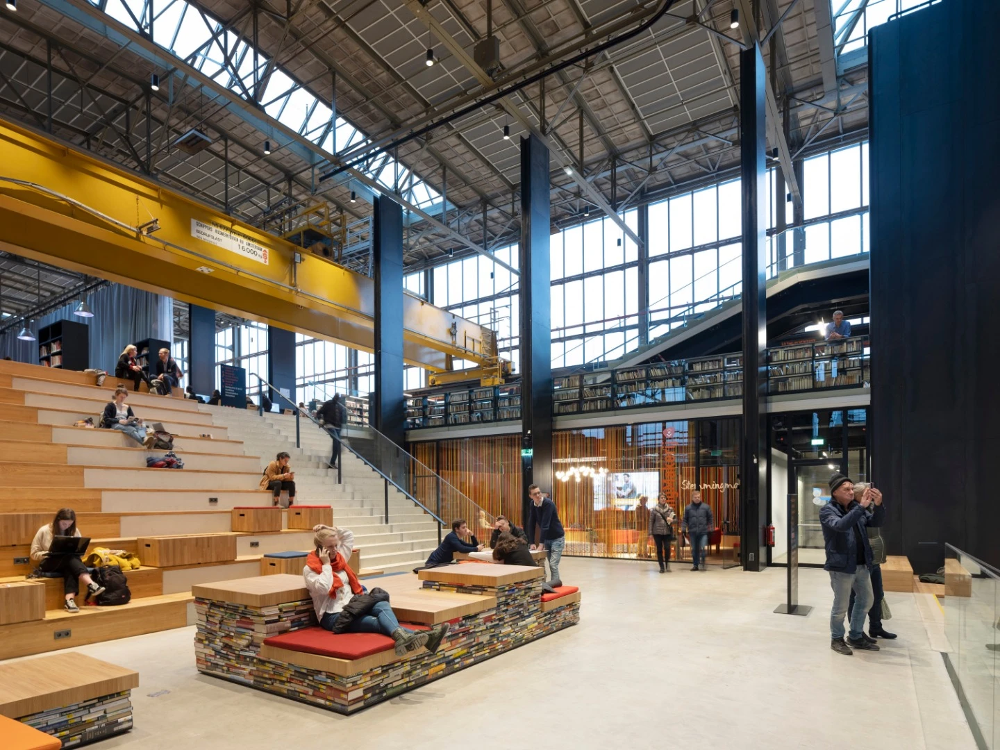 Dutch architecture firm Mecanoo has added the finishing touches to an impressive interior space inside an old railway station, rebirthing it as an “urban living room” called the LocHal Library