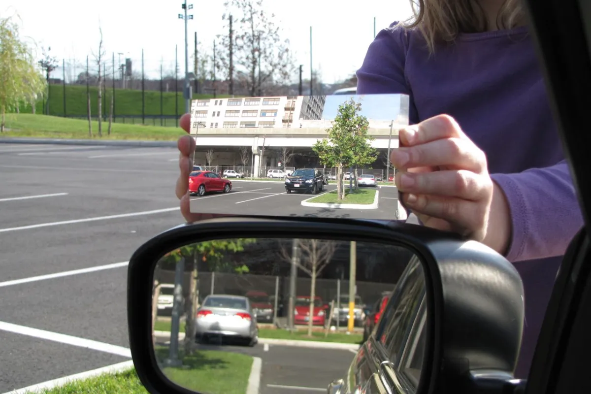 Dr. Hicks' mirror (top) as compared to a regular flat driver's side mirror