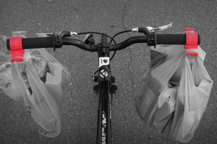 The Bag Buddy is a simple handlebar clamp designed to make carrying shopping bags on a bicycle easier
