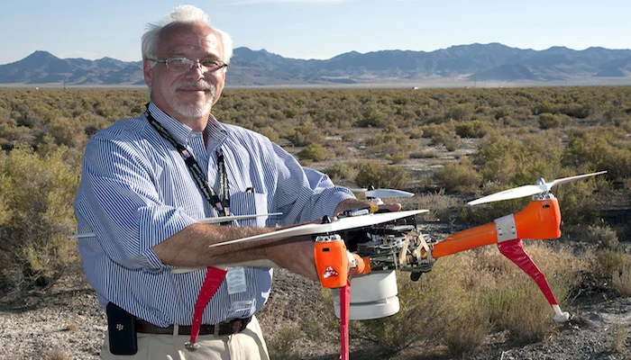 ECBC Director, Joseph Corriveau, with Deep Purple, one of two drones used to sniff out chemical and biological agents in a recent two-week test