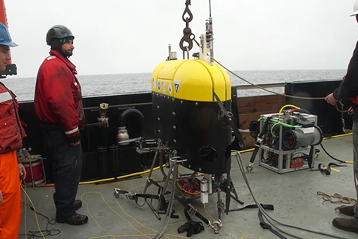Engineers from Woods Hole Oceanographic Institution and ship’s crew on the R/V Rachel Carson prepare to launch the Mesobot into Monterey Bay