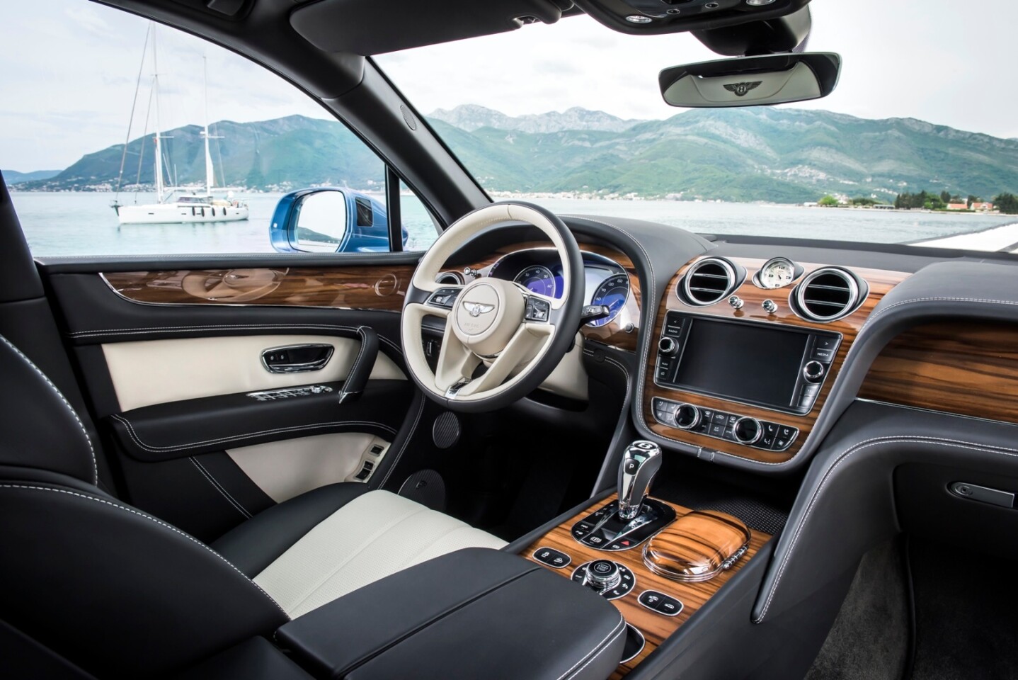 The interior comprises a variety of veneered woods and metal elements