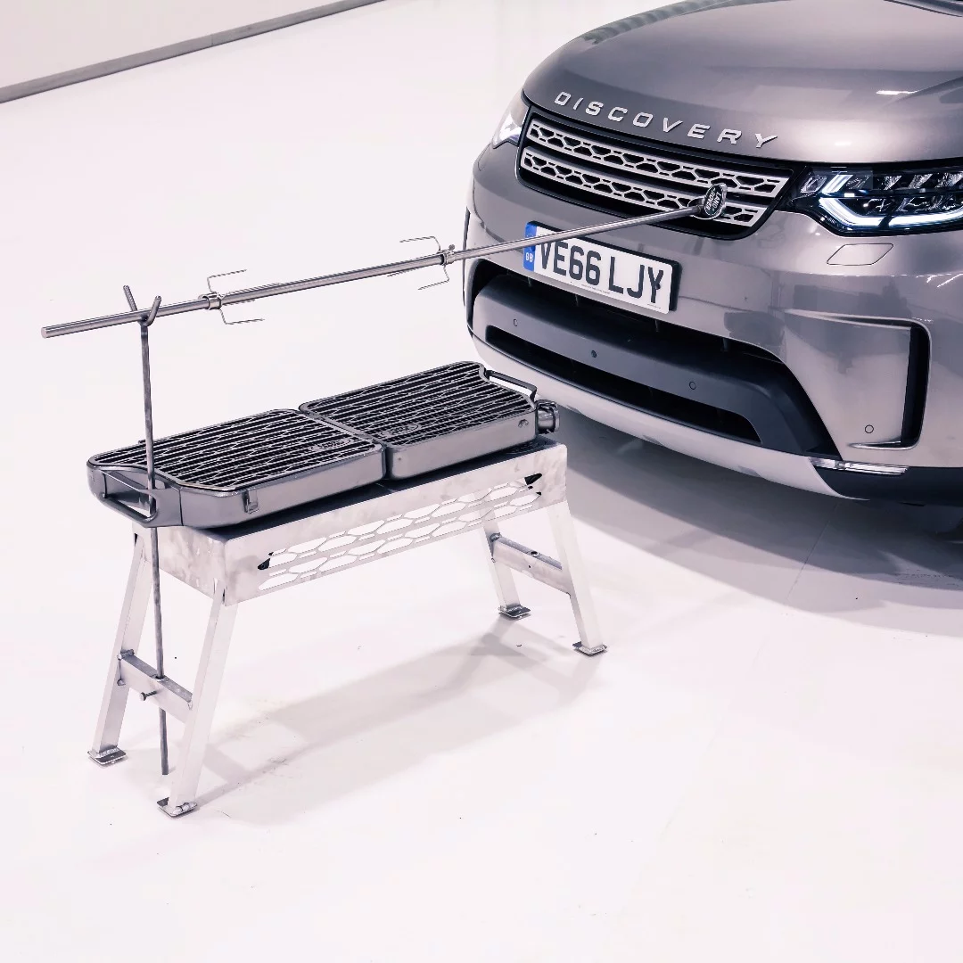 The build includes a standalone, folding charcoal/wood grill built from a jerry can with a Land Rover grille-inspired cooking surface