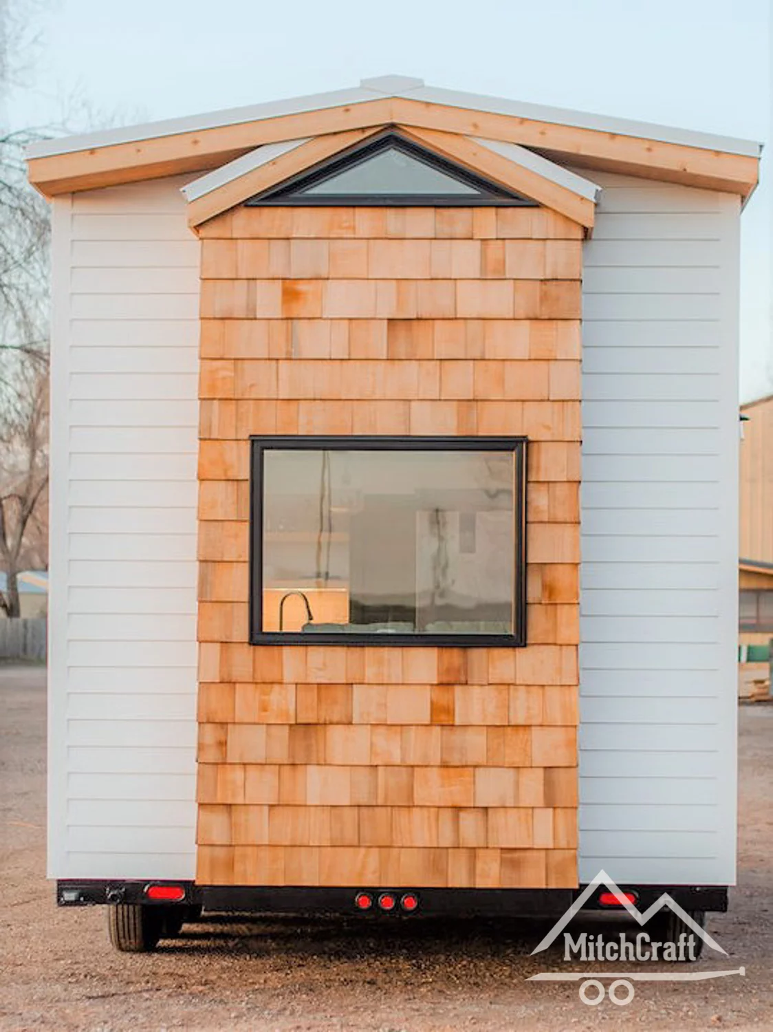 A large back window offers extra lighting inside, plus lush outdoor views