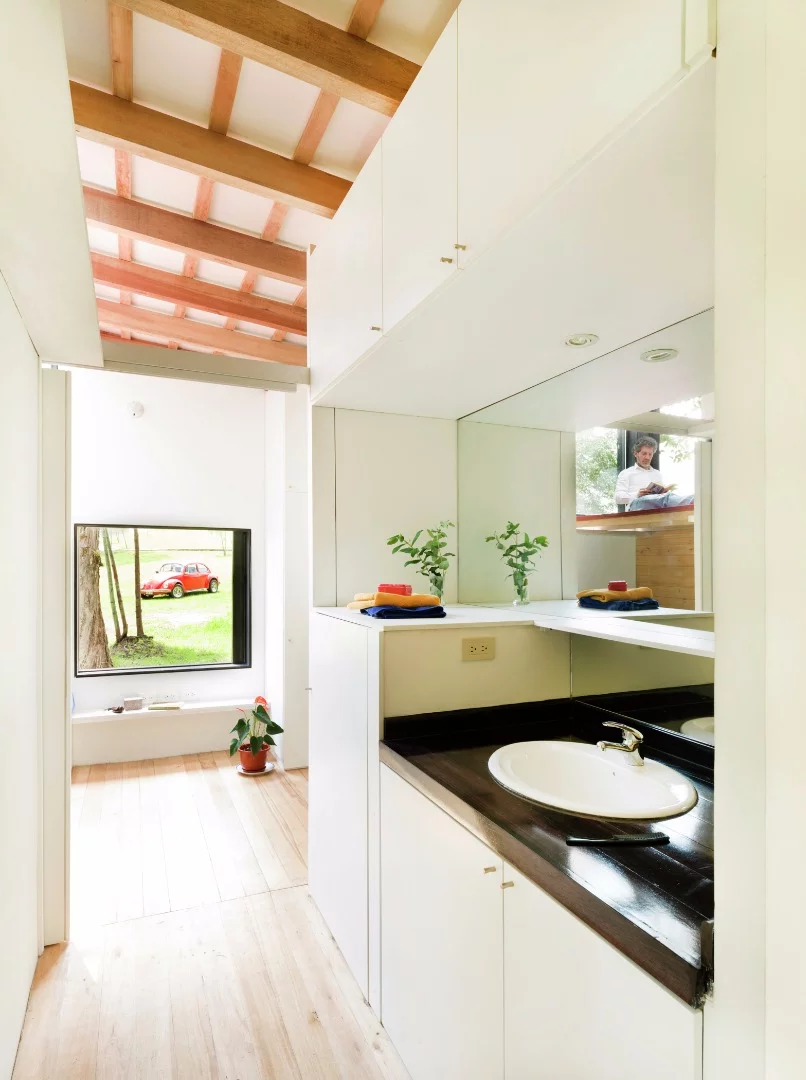 A fully-equipped bathroom is located in the center of the home