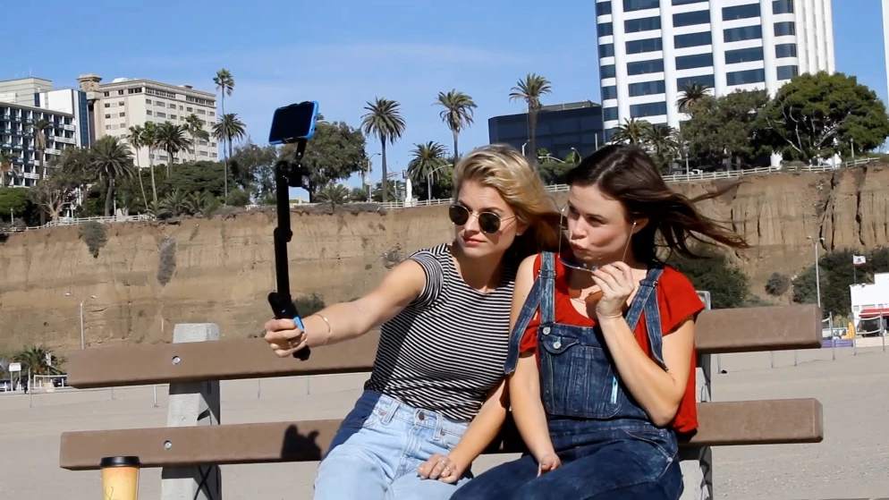 The Morphi in selfie stick mode, with its Bluetooth remote attached