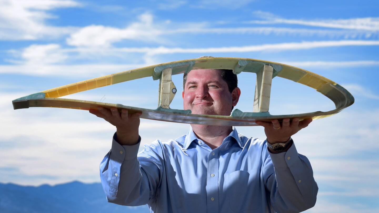 Design team member Todd Griffiths with a model of a 50 m blade segment, which forms part of Sandia's roadmap to the new exascale design