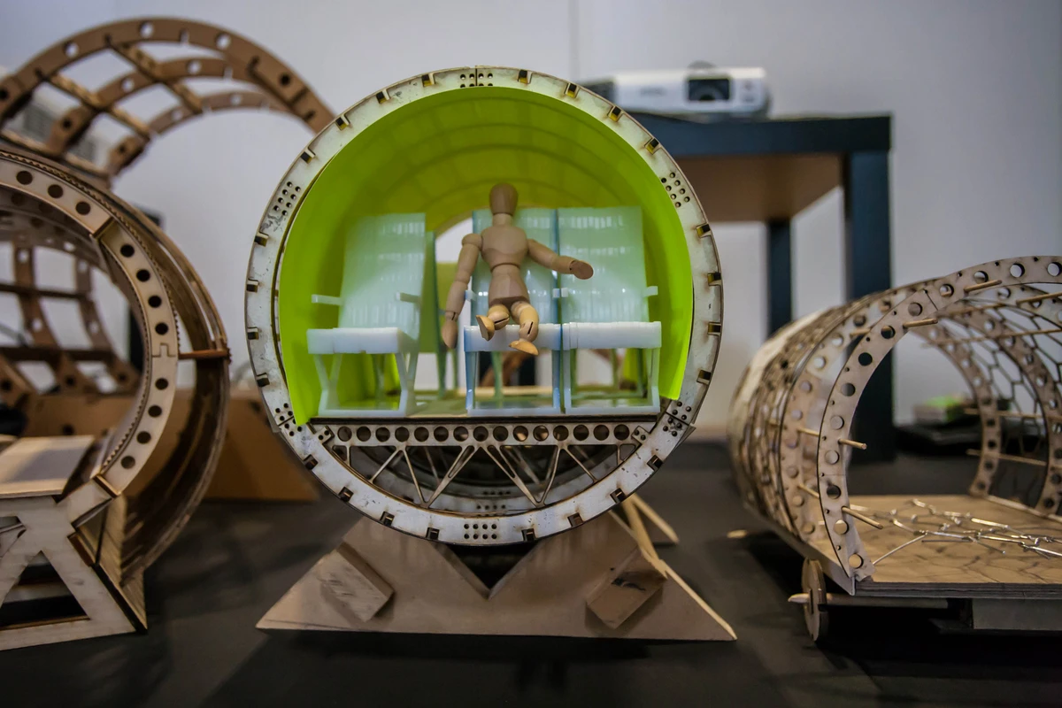Miniature wood model of the Hyperloop with passenger