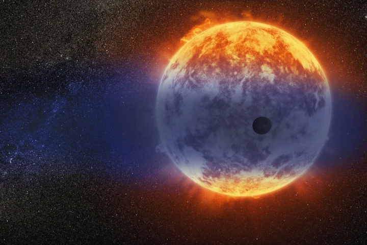 An illustration of GJ 3470b, shrouded in a cloud of gas as its atmosphere is stripped away thanks to the heat of its host star
