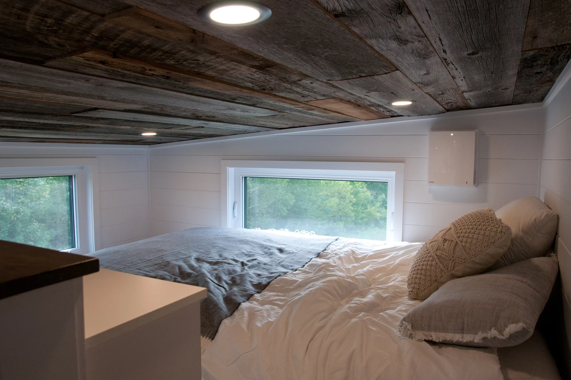 The Baobab's bedroom only loft bedroom, with the low ceiling typical of tiny houses