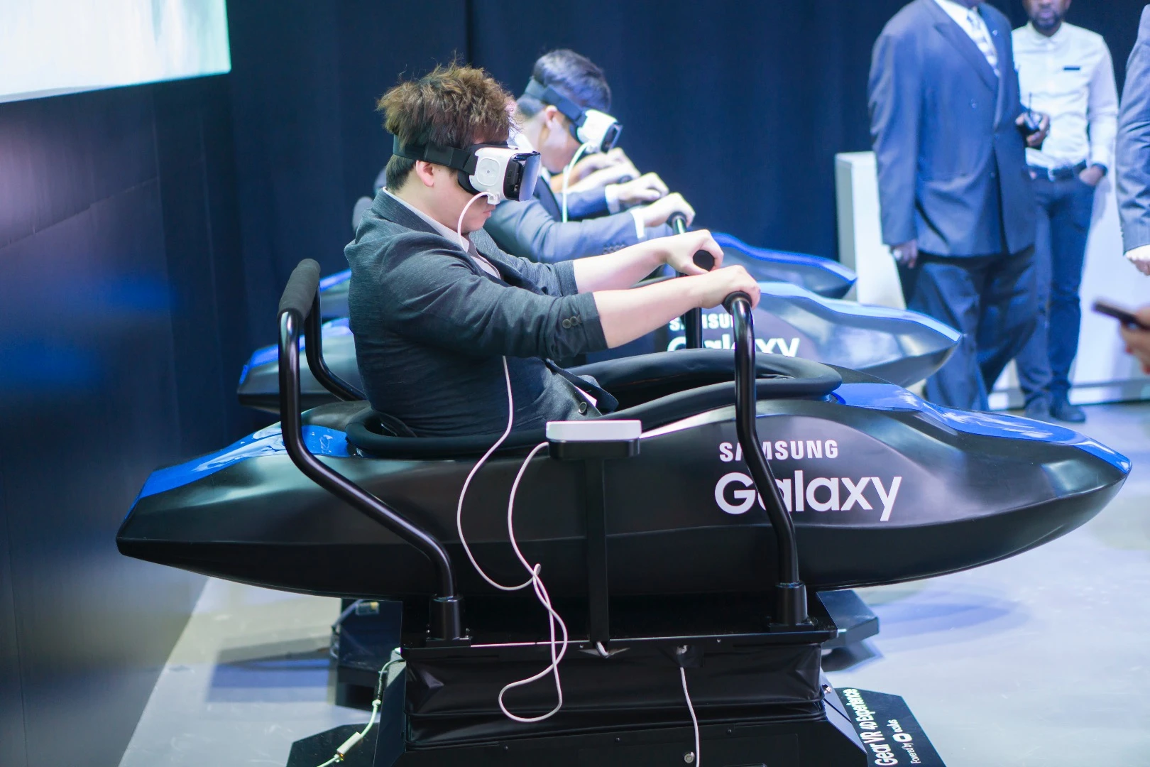 Samsung event attendees conducting some serious business, using the older Gear VR