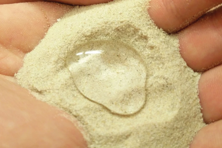 A sample of the KAUST team's purified-paraffin-wax-coated Superhydrophobic Sand (SHS)