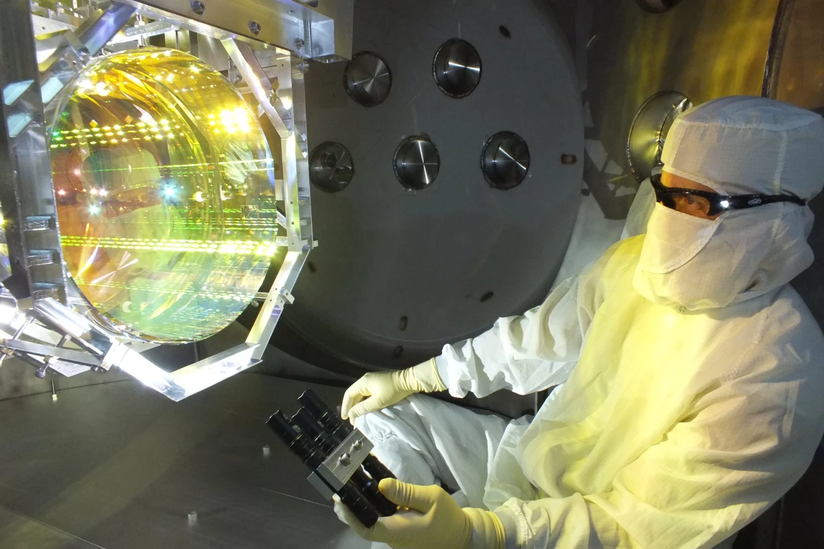 A scientist inspecting one of LIGO's mirrors, which has now been measurably affected by quantum fluctuations