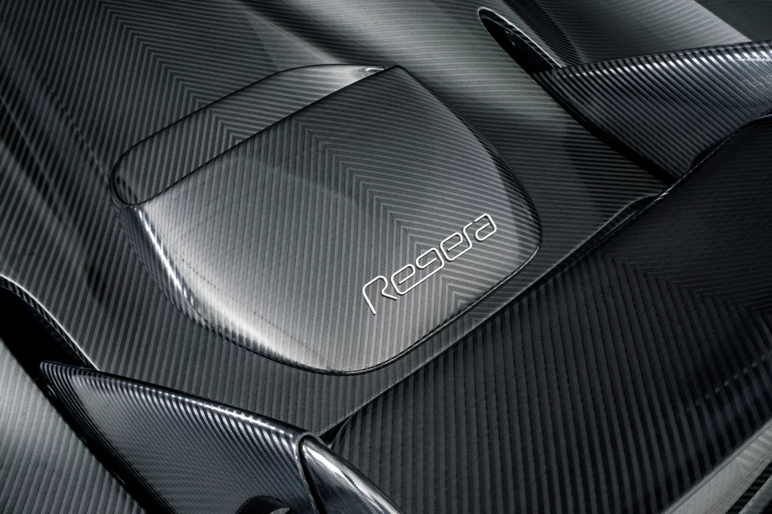 Koenigsegg's KNC Regera: the naked carbon has a graphite-like sheen as the light catches the strands