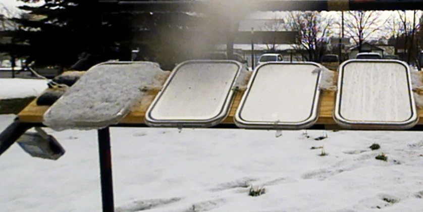 SLUGs coatings repel snow and ice on the right three panels, while it builds up on the far left untreated panel