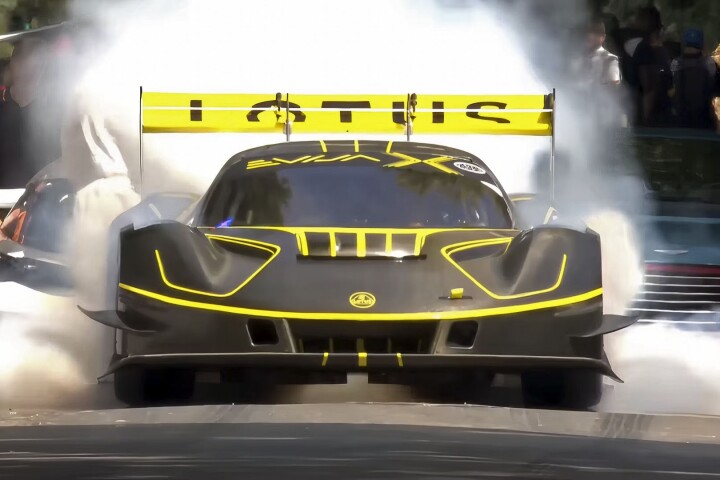 The Lotus Evija X does a huge smokey burnout leaving the start line before crashing violently into the hay bales