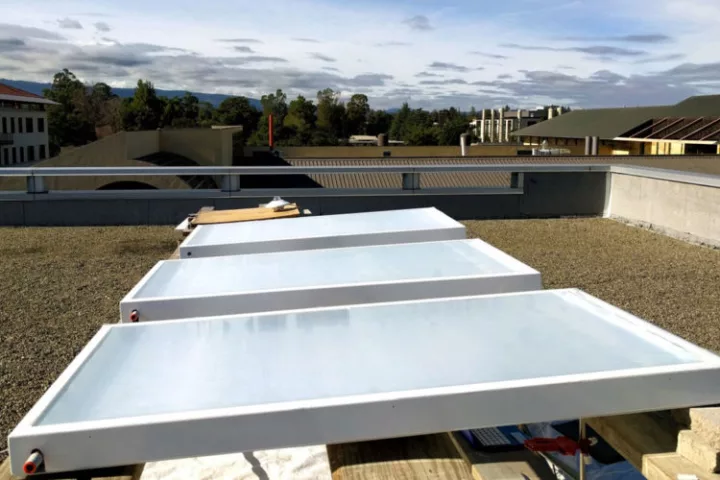 Radiative sky cooling systems use reflective panels to emit heat into space, potentially cooling a building in the process