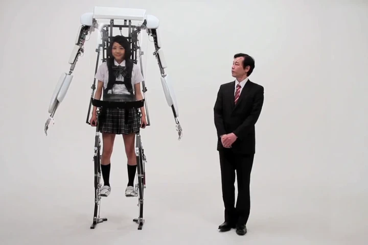 A school girl wearing Sagawa Electronics' Power Jacket MK3 stands above a grown man