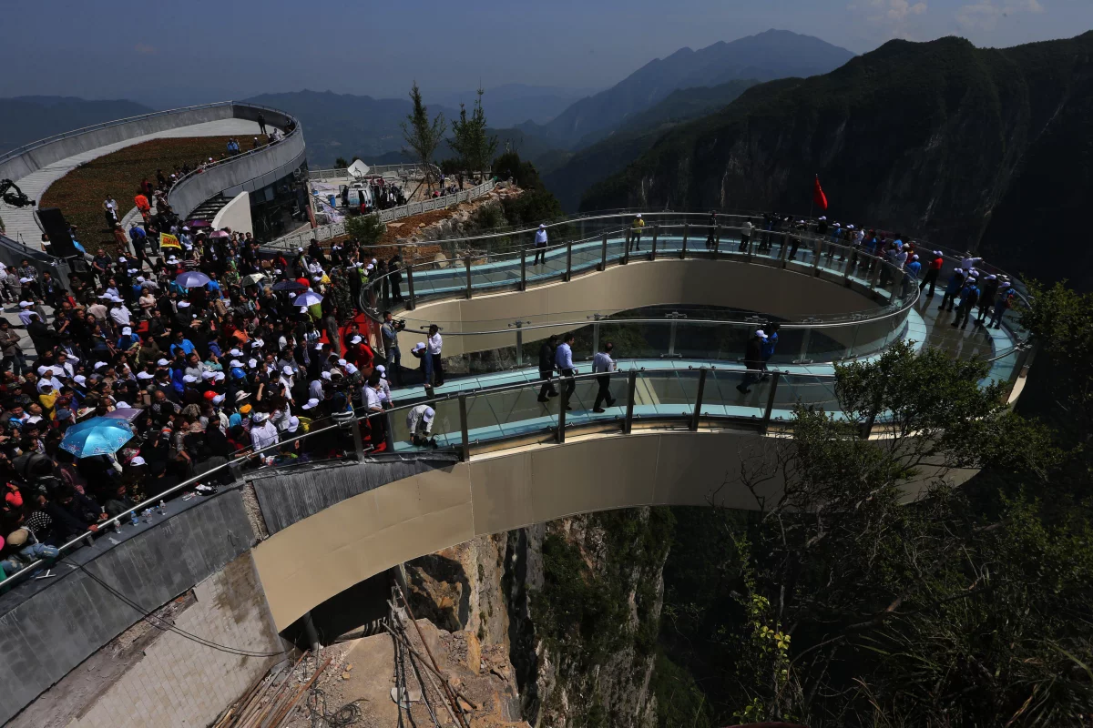 The world's longest glass-bottomed cantilever skywalk has tourists contemplating a 718 m (2,356 ft) drop to the rocks below (Photo: Imaginechina)