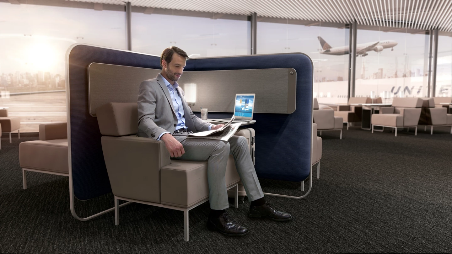 Bespoke lounge seating with high sides provides privacy, as well as storage for coats and bags, pull out tables with integrated tablet holders and charging points