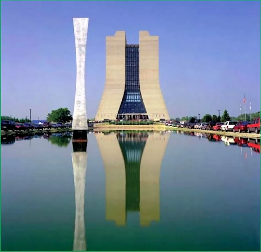 Wilson Hall viewed over the reflecting pond, with the Hyperbolic Obelisk at its side (Photo: Fermilab)