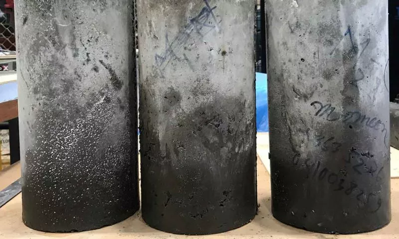 Three samples of the cured concrete, which meets building codes and is lighter than concrete containing a traditional aggregate